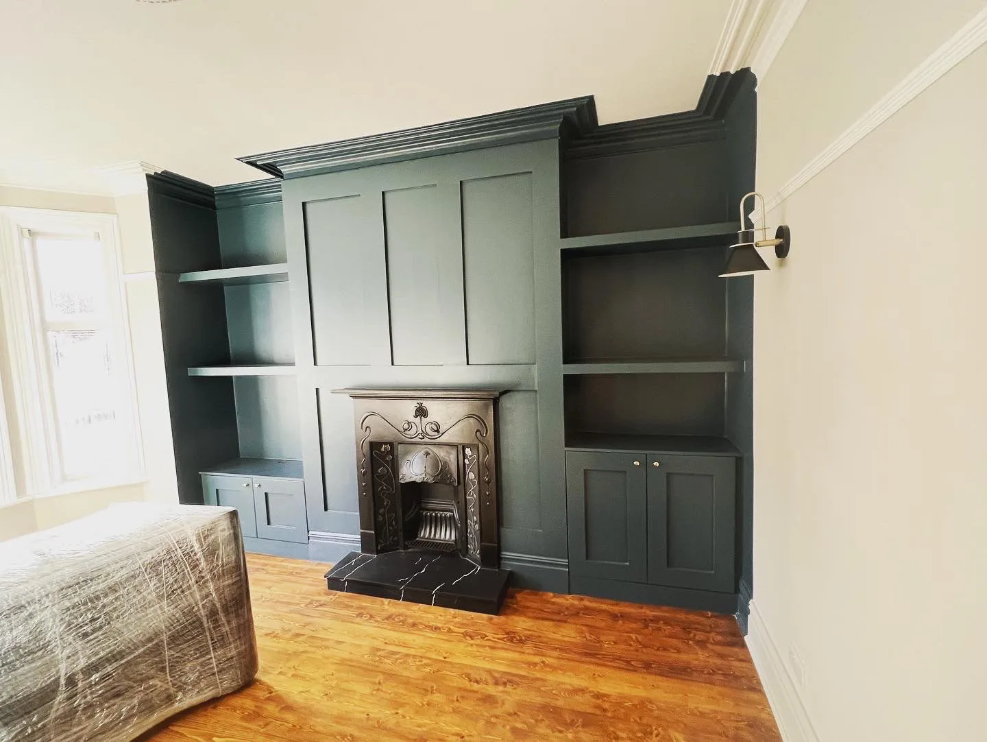 Dark green bespoke alcove units with period fireplace by LDG Joinery LTD