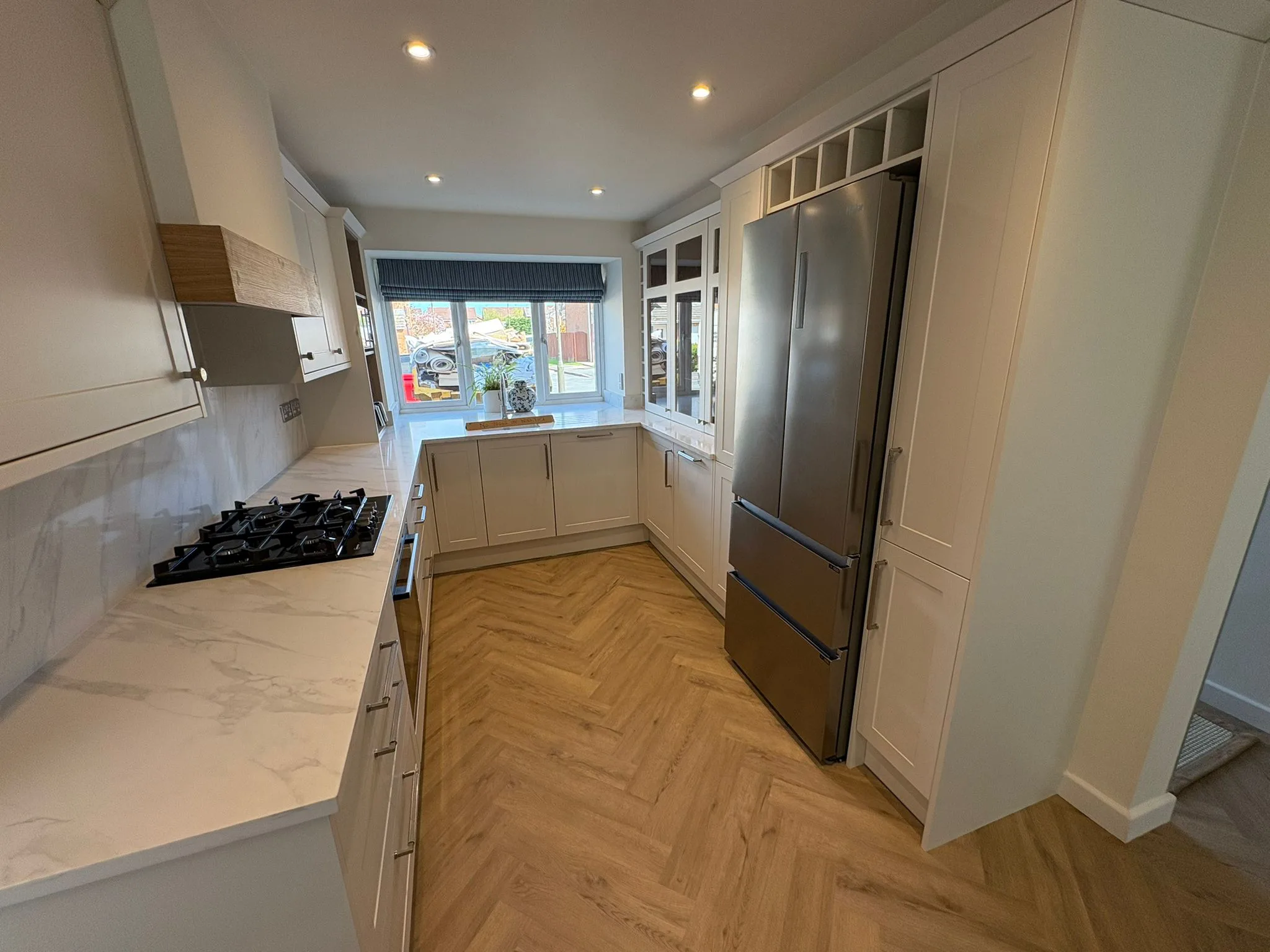 White shaker fitted kitchen with herringbone flooring by LDG Joinery LTD