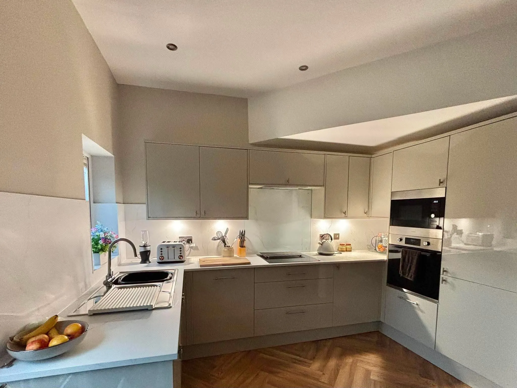 Cream gloss fitted kitchen with recessed ceiling detail by LDG Joinery LTD, Bolton